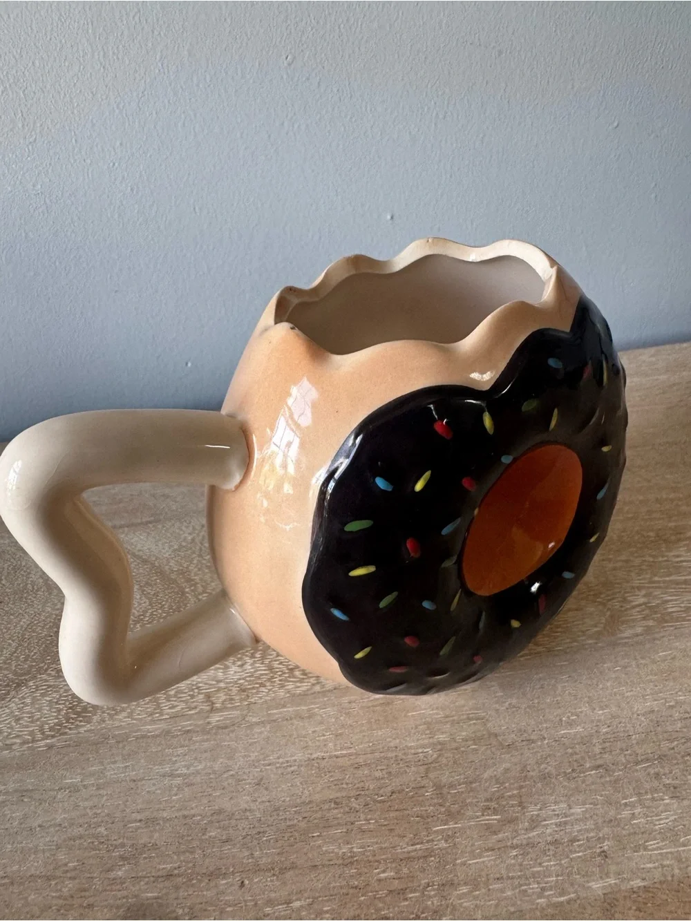 Donut-Shaped Ceramic Mug with Black Frosting and Tan Body